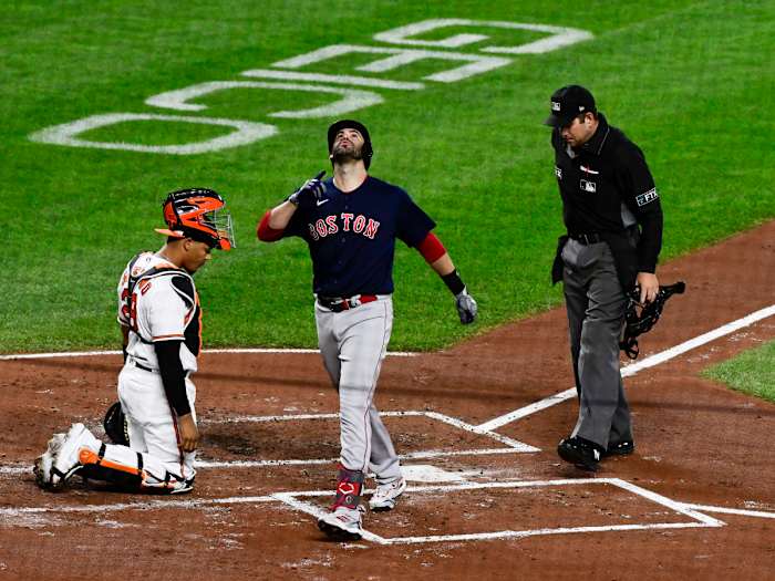Sep 29, 2021; Baltimore, Maryland, USA; Boston Red Sox left fielder J.D. Martinez (28) celebrates hitting a second inning solo home run as Baltimore Orioles catcher Pedro Severino (28) looks on at Oriole Park at Camden Yards.